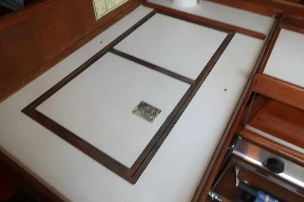 Slide: The Image of 1979 Tartan T 37 yacht interior with wooden cabinetry and white countertop. - 19
