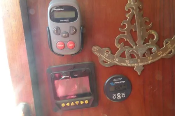 Slide: The Image of 1979 Tartan T 37 yacht control panel with navigation instruments and decorative brass compass. - 20