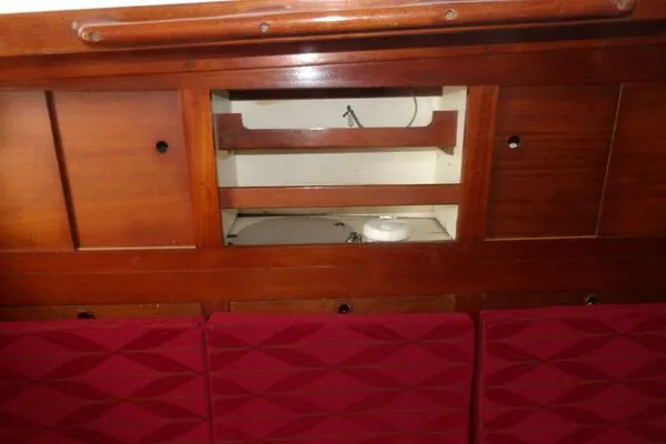 Slide: The Image of Wooden interior of 1979 Tartan T 37 sailboat with red cushioned seating. - 21