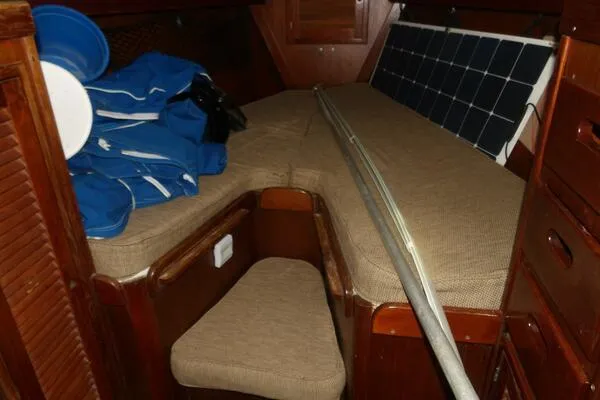 Slide: The Image of Interior of 1979 Tartan T 37 sailboat with storage, solar panel, and blue gear. - 29