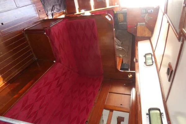 Slide: The Image of Interior of a 1979 Tartan T 37 sailboat with red upholstery and wooden finishes. - 30