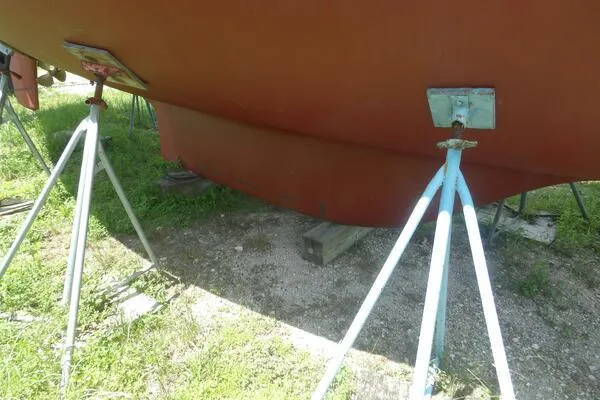 Slide: The Image of 1979 Tartan T 37 sailboat hull supported by stands on grassy ground. - 40