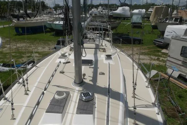 Slide: The Image of 1979 Tartan T 37 sailboat deck view in a boatyard setting. - 6
