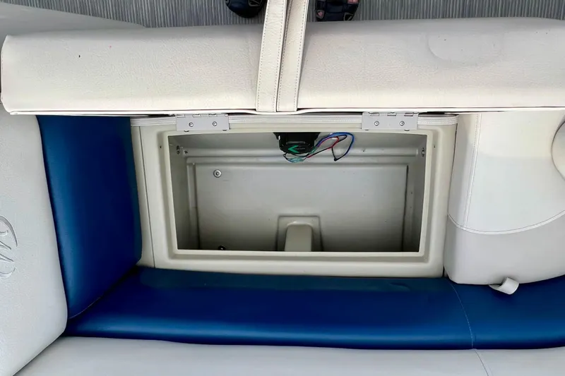 Slide: The Image of Open storage compartment in 2018 Manitou 23 Aurora LE boat seat. - 16