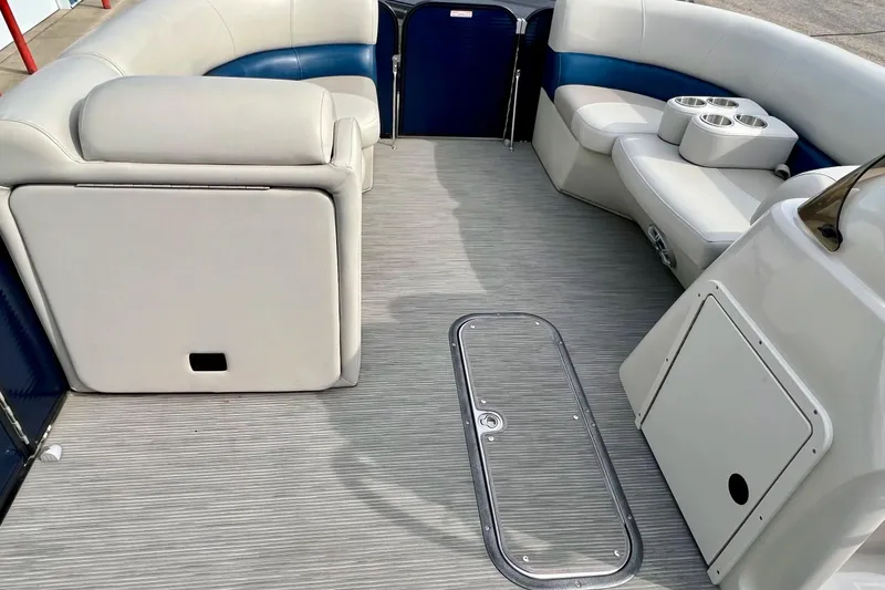 Slide: The Image of 2018 Manitou 23 Aurora LE boat interior with gray flooring and white seating. - 23