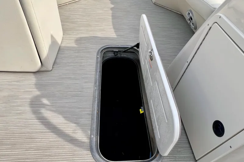 Slide: The Image of Open storage compartment on 2018 Manitou 23 Aurora LE boat deck. - 27