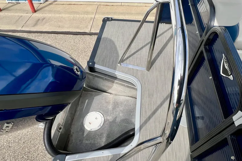 Slide: The Image of 2018 Manitou 23 Aurora LE boat with blue motor and sleek deck design. - 32