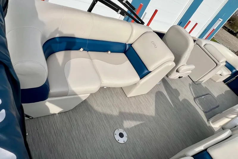 Slide: The Image of 2018 Manitou 23 Aurora LE boat interior with blue and white seating. - 33