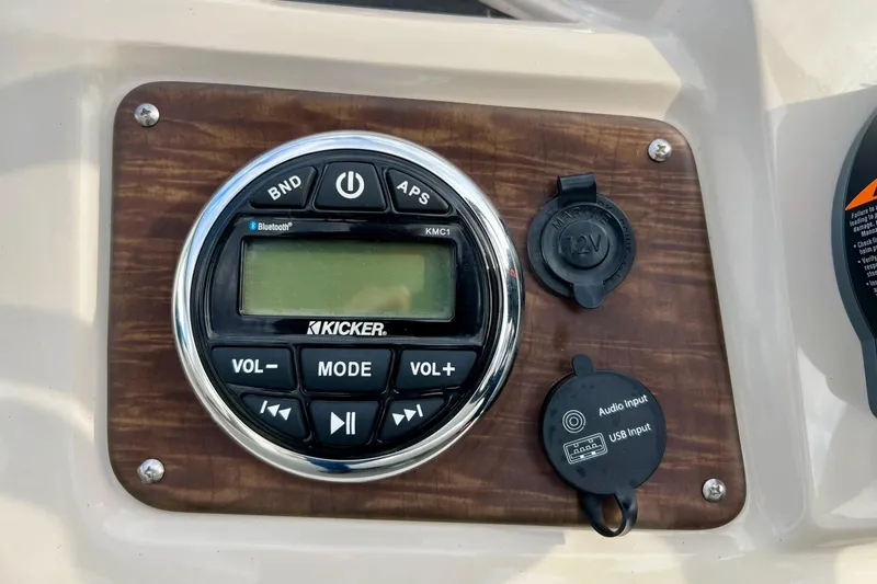 Slide: The Image of Kicker audio system on 2018 Manitou 23 Aurora LE boat dashboard. - 45
