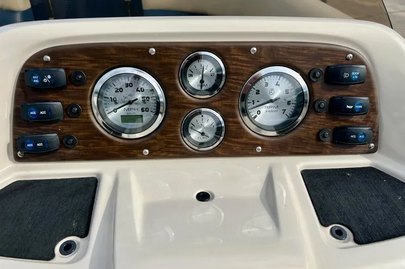 Slide: The Image of Dashboard of 2018 Manitou 23 Aurora LE with gauges and control switches. - 46