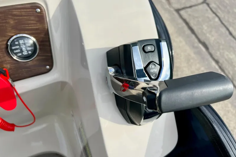 Slide: The Image of Close-up of 2018 Manitou 23 Aurora LE boat throttle and control panel. - 47