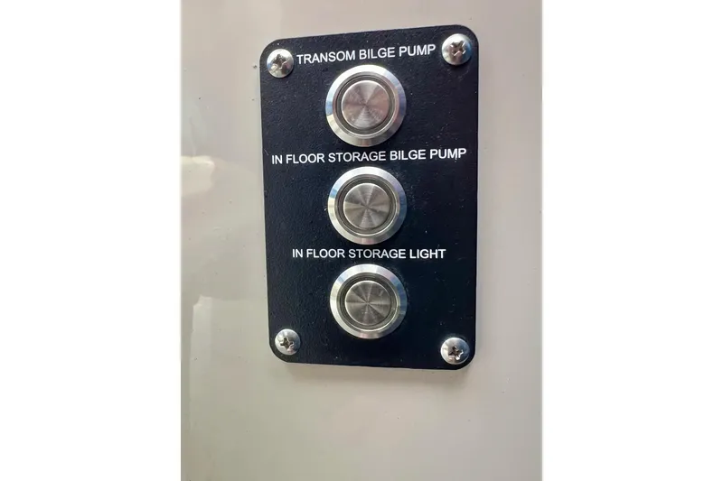 Slide: The Image of Control panel with buttons for bilge pumps and storage light on 2018 Manitou 23 Aurora LE. - 48