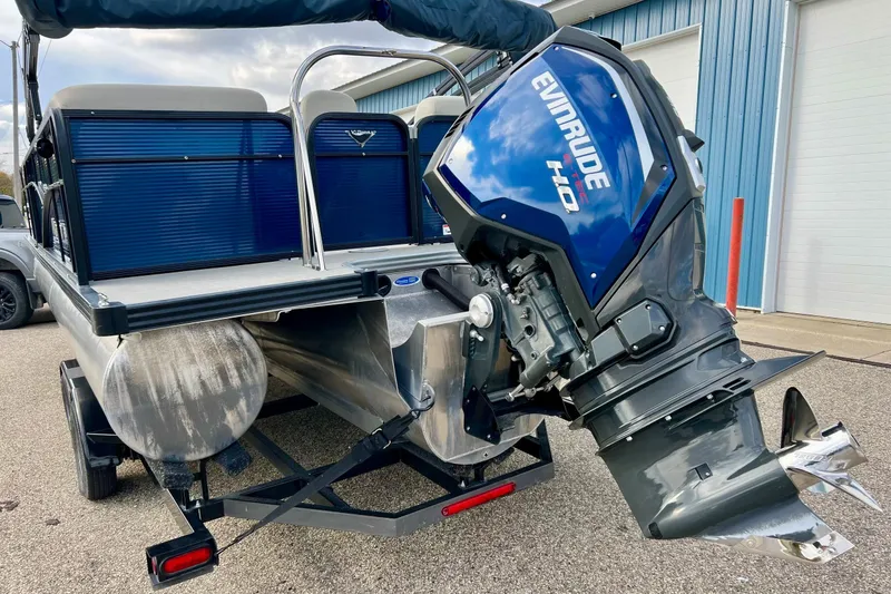 Slide: The Image of 2018 Manitou 23 Aurora LE pontoon boat with Evinrude outboard motor, parked on trailer. - 59