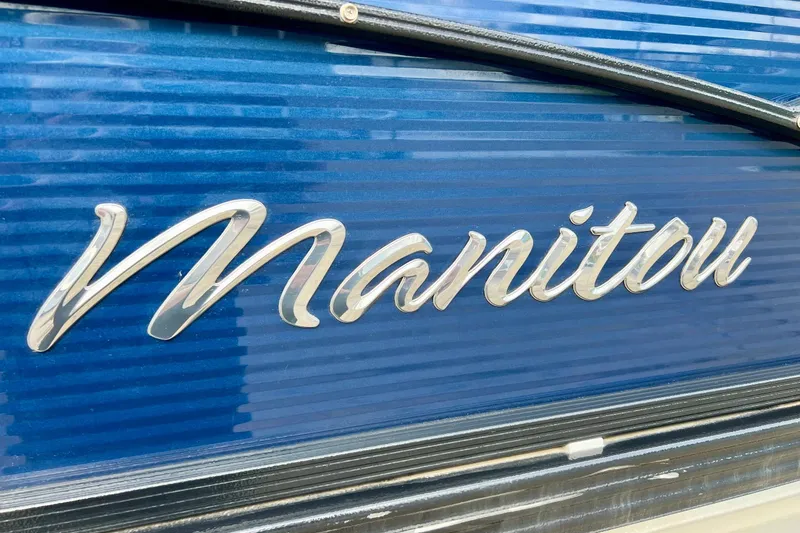 Slide: The Image of Manitou 23 Aurora LE 2018 logo on blue background, close-up view. - 6