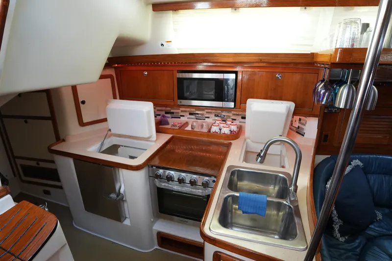 Slide: The Image of Interior of 2002 Catalina 42 Mark II yacht kitchen with sink, stove, and microwave. - 21
