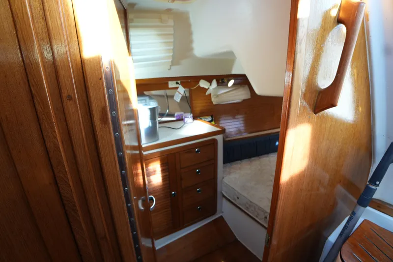 Slide: The Image of Interior cabin of 2002 Catalina 42 Mark II sailboat with wooden finish and cozy bed. - 26