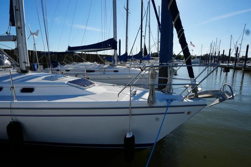 Slide: The Image of 2002 Catalina 42 Mark II sailboat docked in a marina under clear blue skies. - 3