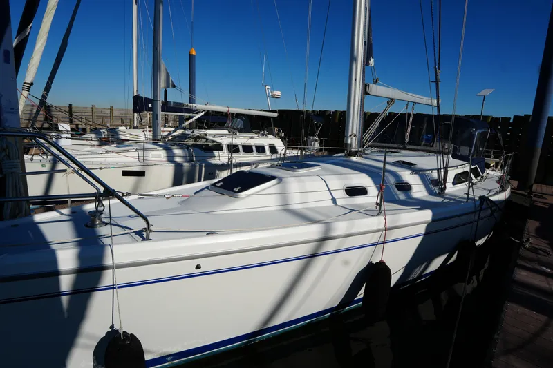 Slide: The Image of 2002 Catalina 42 Mark II sailboat docked in marina under clear blue sky. - 5