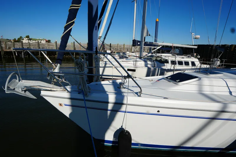 Slide: The Image of Catalina 42 Mark II sailboat docked, 2002 model, with clear blue sky background. - 6