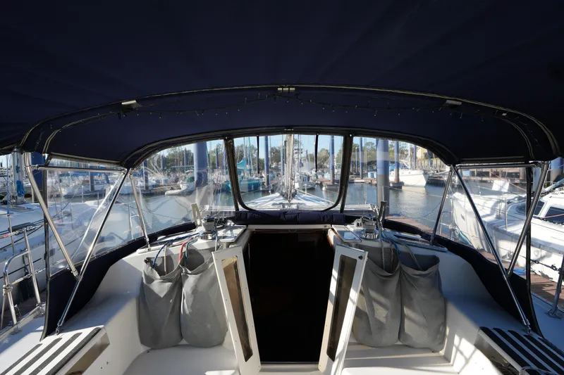 Slide: The Image of Cockpit view of a 2002 Catalina 42 Mark II sailboat docked at a marina. - 10