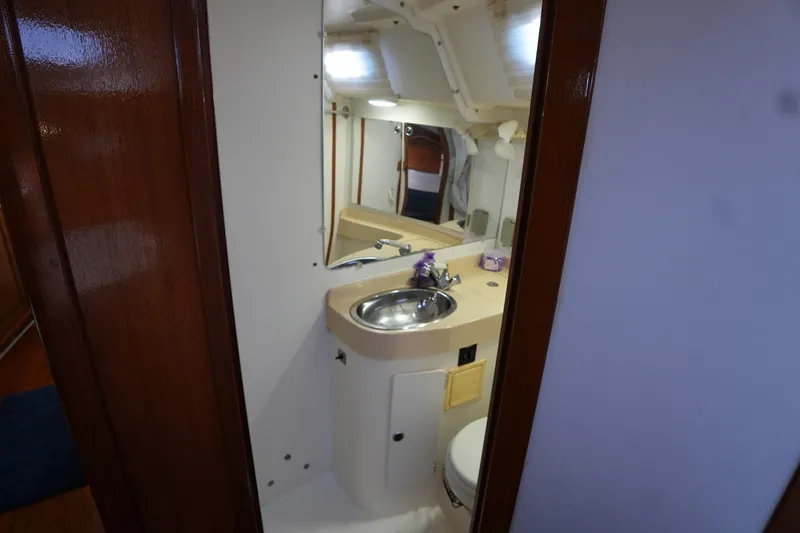 Slide: The Image of Interior of 2002 Catalina 42 Mark II yacht bathroom with sink and mirror. - 15