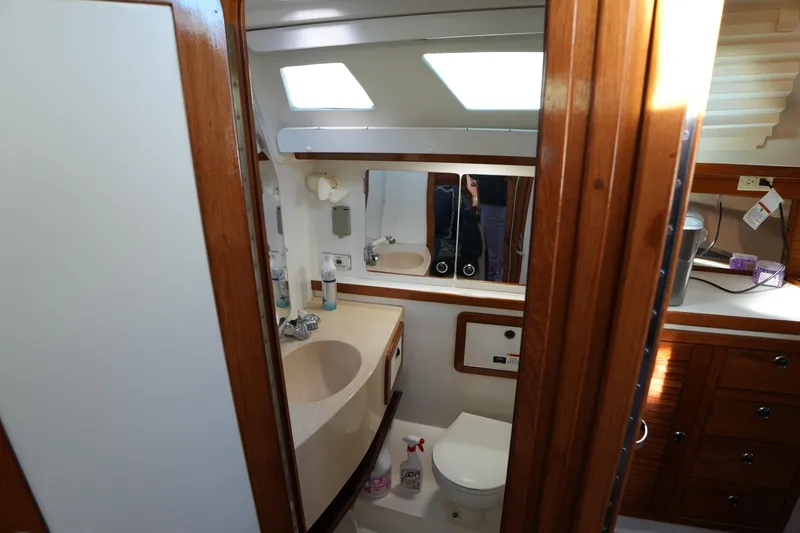 Slide: The Image of Bathroom interior of 2002 Catalina 42 Mark II yacht, featuring wooden cabinetry and modern fixtures. - 25