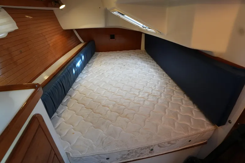 Slide: The Image of Interior cabin of 2002 Catalina 42 Mark II sailboat with cozy bed and wooden paneling. - 27