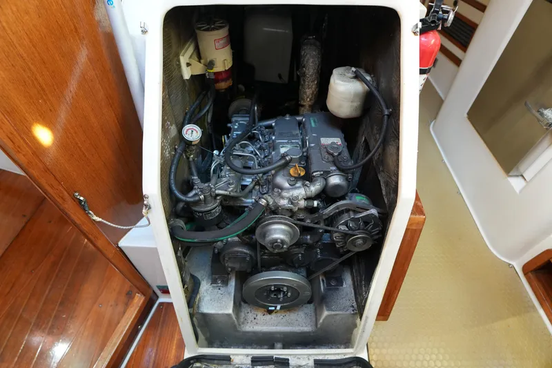 Slide: The Image of Engine compartment of a 2002 Catalina 42 Mark II sailboat, showcasing mechanical components. - 28