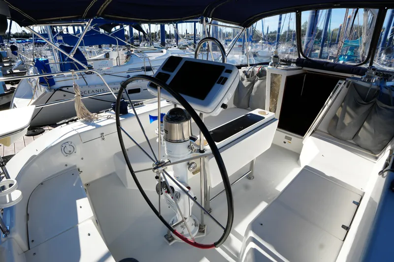 Slide: The Image of Cockpit of 2002 Catalina 42 Mark II sailboat with steering wheel and navigation equipment. - 9