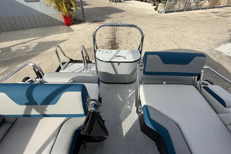 Slide: The Image of 2026 Avalon 2385 Catalina Quad Lounger, Tri Toon boat interior with blue and white seating. - 23