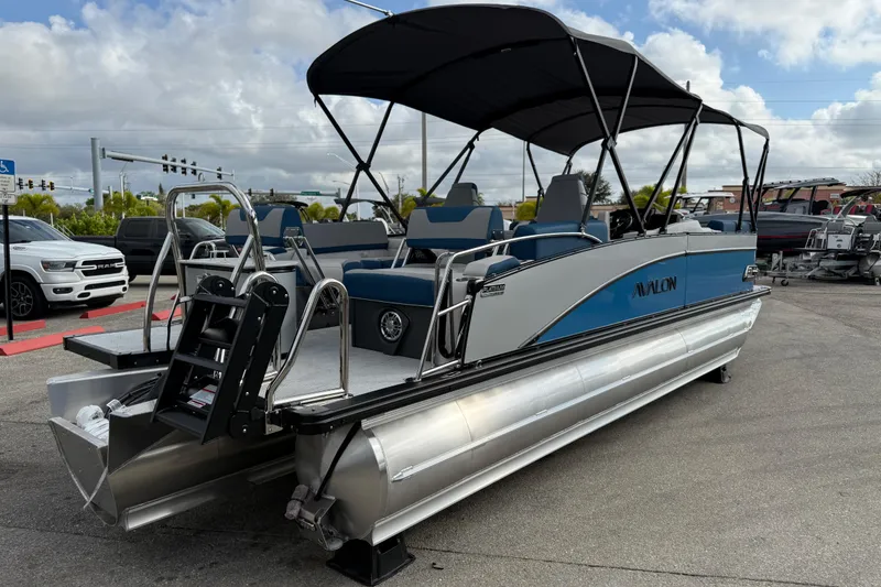 Slide: The Image of 2026 Avalon 2385 Catalina Quad Lounger Tri Toon boat with canopy, parked outdoors. - 7