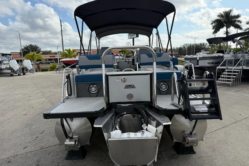 Slide: The Image of 2026 Avalon 2385 Catalina Quad Lounger Tri Toon boat, rear view, in a marina setting. - 8