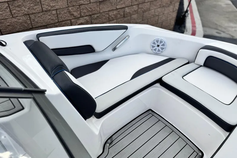 Slide: The Image of 2021 Yamaha Boats 195S interior with white and black seating, speaker, and wood-style flooring. - 13
