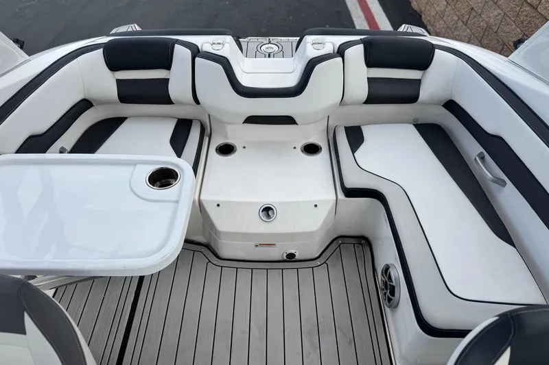 Slide: The Image of 2021 Yamaha Boats 195S interior with white and black seating, table, and cup holders. - 17