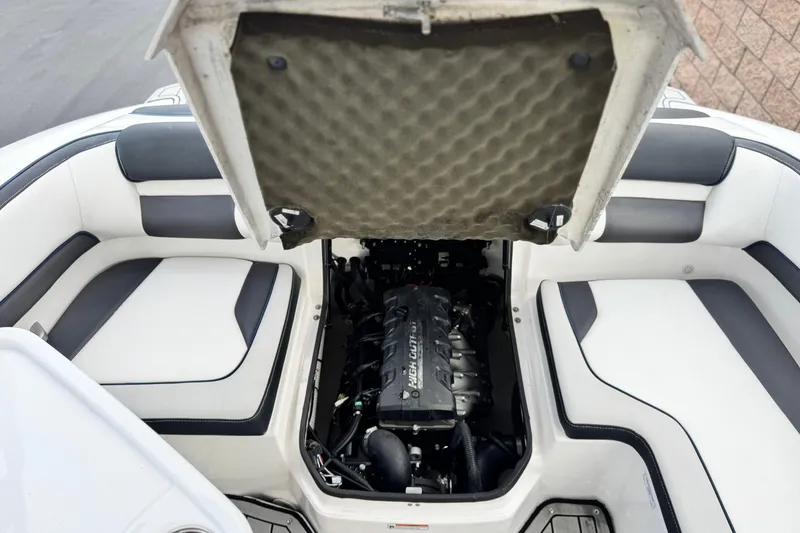 Slide: The Image of 2021 Yamaha Boats 195S engine compartment with open hatch, showcasing interior seating. - 18