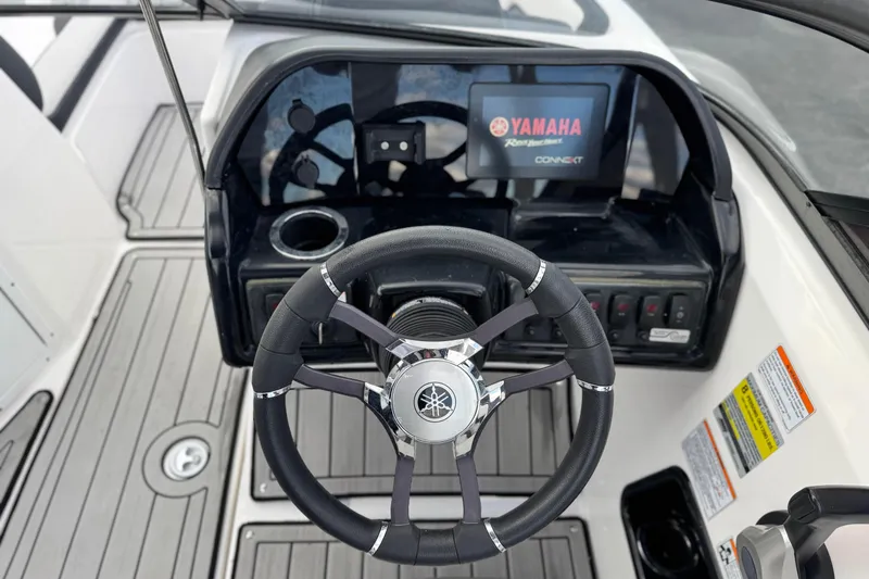 Slide: The Image of 2021 Yamaha Boats 195S dashboard with steering wheel and digital display. - 24