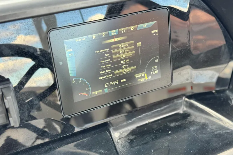 Slide: The Image of Dashboard display of a 2021 Yamaha Boats 195S showing fuel and trip information. - 26