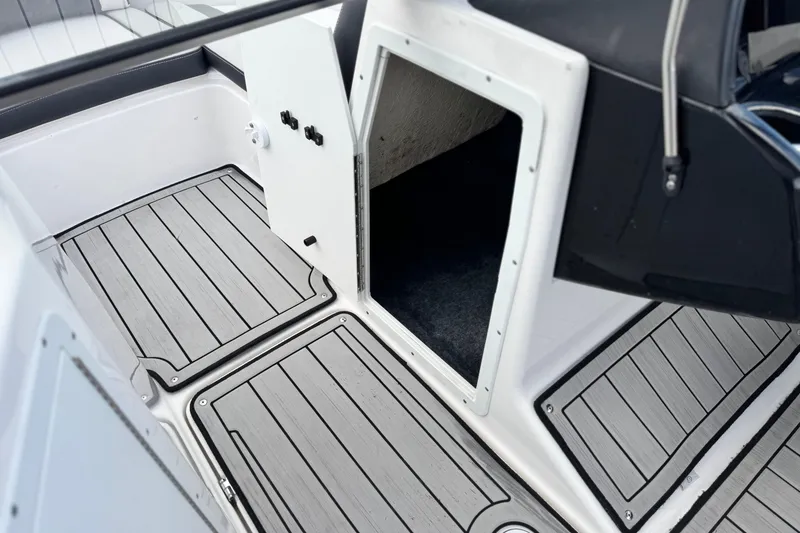 Slide: The Image of 2021 Yamaha Boats 195S interior with sleek flooring and storage compartment. - 28