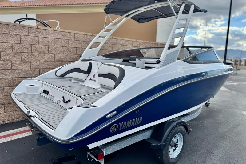 Slide: The Image of 2021 Yamaha Boats 195S with sleek design and modern features, parked on a trailer. - 5