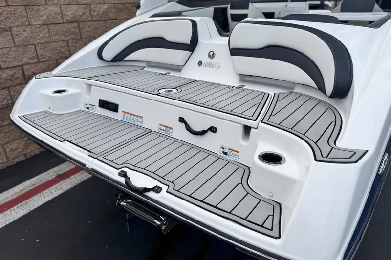 Slide: The Image of 2021 Yamaha Boats 195S swim platform with cushioned seating and sleek design. - 7