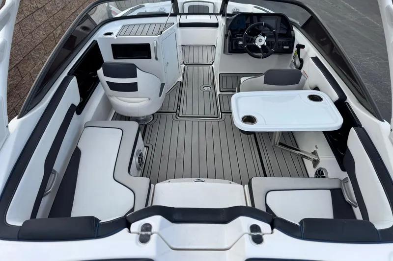 Slide: The Image of 2021 Yamaha Boats 195S interior with seating, table, and steering console. - 9