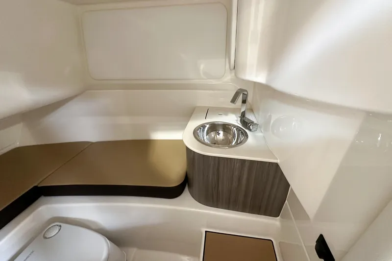 Slide: The Image of 2026 Sea Ray SDX 250 interior cabin with sink and seating area. - 13