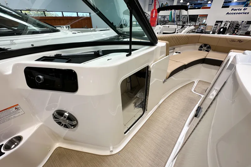 Slide: The Image of 2026 Sea Ray SDX 250 boat interior with beige seating and modern dashboard. - 19