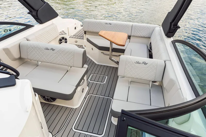 Slide: The Image of Manufacturer Provided Image: 2025 Sea Ray SDX 250 boat interior with luxurious seating and wooden table. - 7