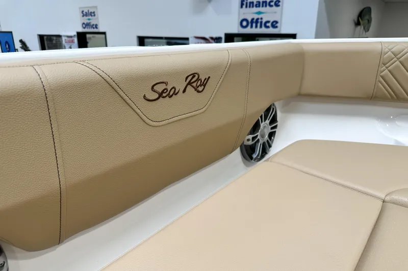 Slide: The Image of 2026 Sea Ray SDX 250 boat interior with beige leather seating and speaker detail. - 17