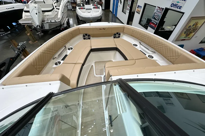 Slide: The Image of 2026 Sea Ray SDX 250 boat interior with tan seating and cup holders. - 15