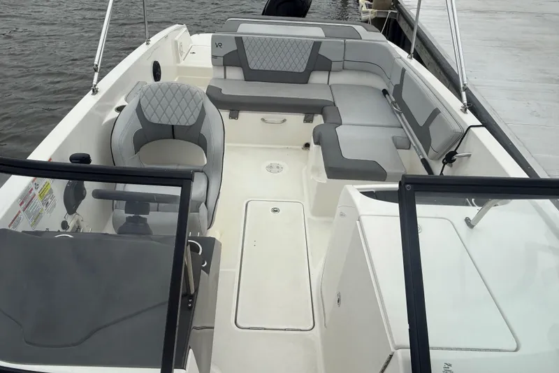Slide: The Image of 2023 Bayliner VR6 Bowrider OB interior with gray seating and steering console. - 4