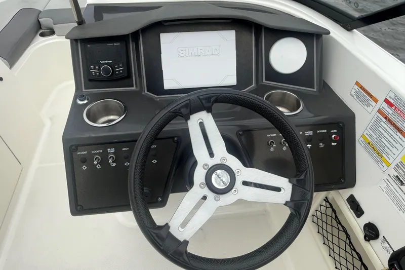 Slide: The Image of 2023 Bayliner VR6 Bowrider OB dashboard with steering wheel and control panel. - 6