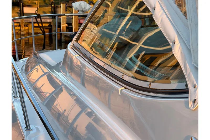 Slide: The Image of 2005 Cruisers Yachts 420 Express reflecting sunlight at a marina. - 3