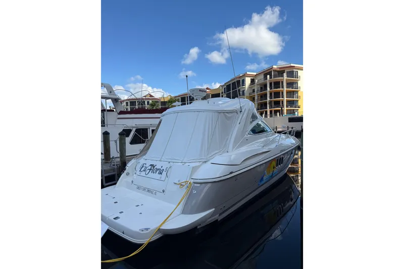 Slide: The Image of 2005 Cruisers Yachts 420 Express docked at marina with clear blue sky. - 4